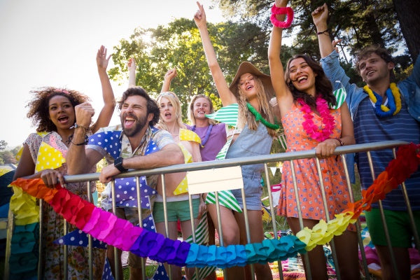 Group of people celebrating outdoors with colorful decorations